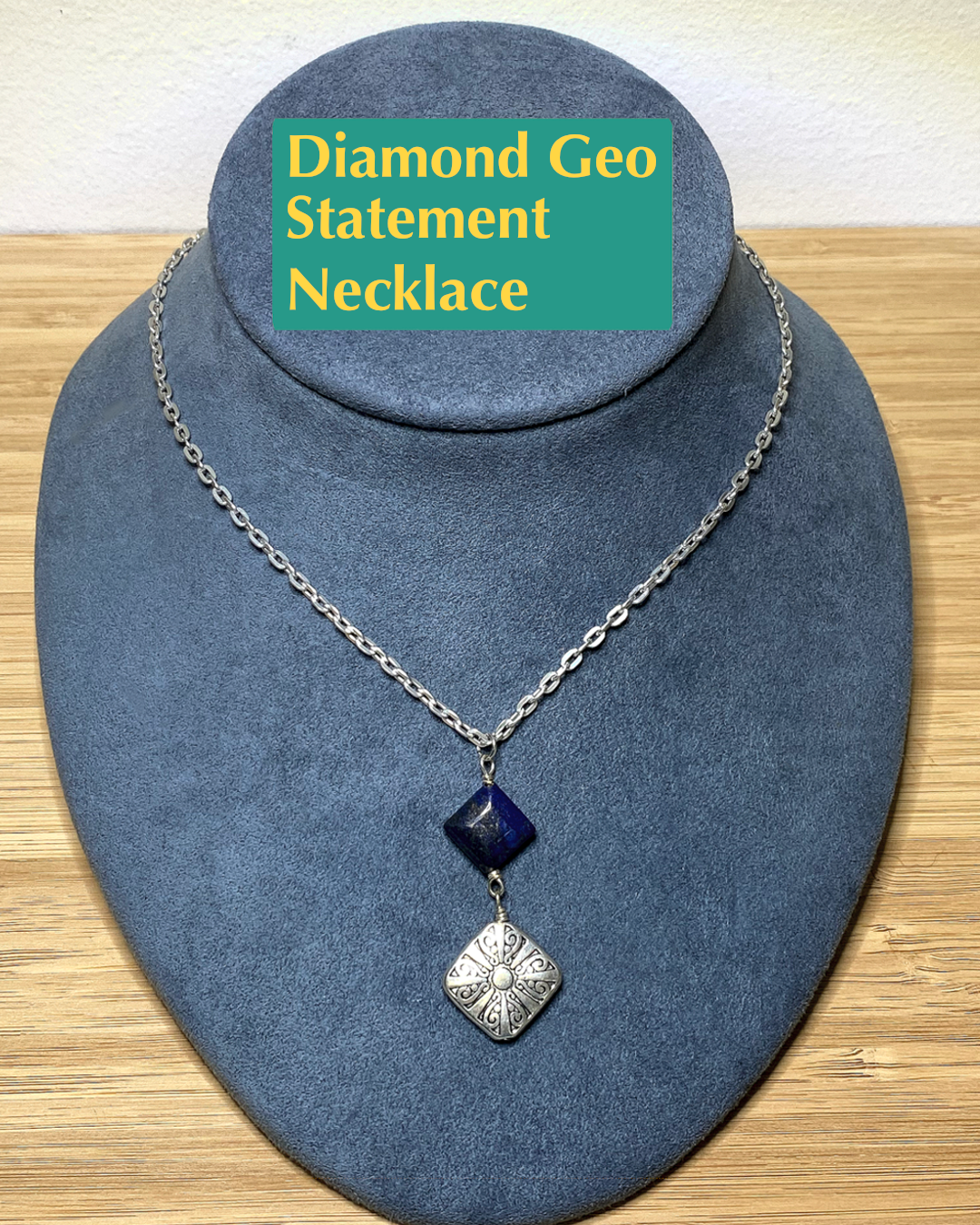 Minimalist silver chain with floral pewter and lapis lazuli pendant.