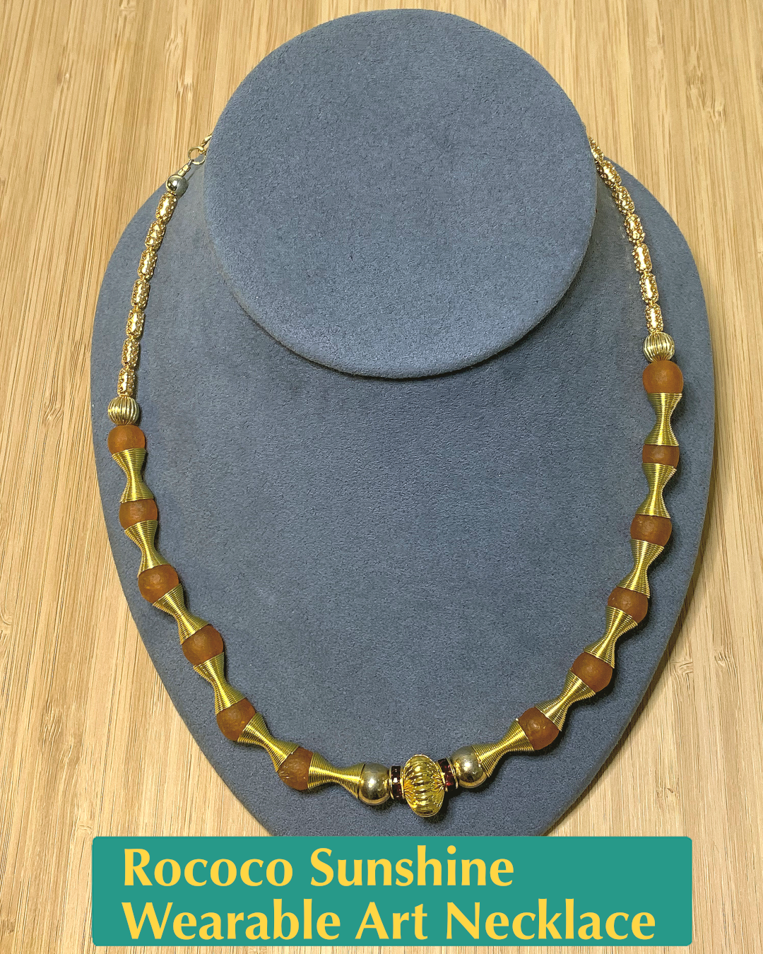 Handmade, wearable art necklace made from orange recycled glass and gold beads of different shapes and textures