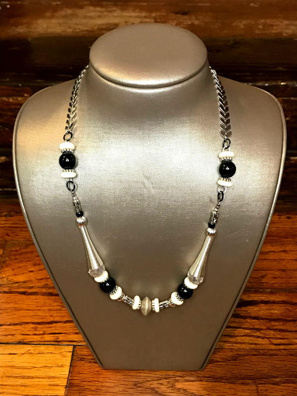 Handmade, wearable art Malian Monochrome necklace on display