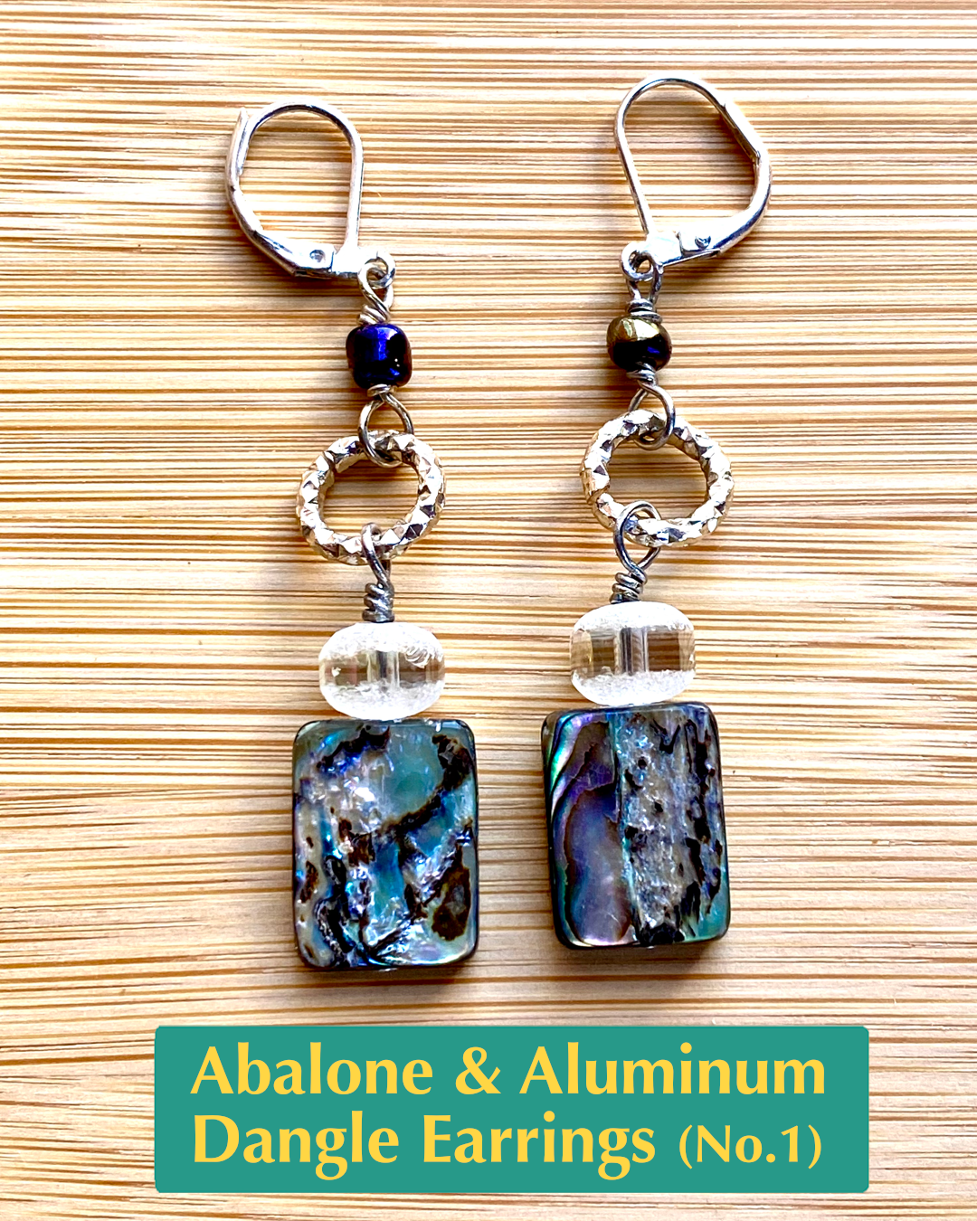 handmade earrings with textured metallic salvaged, aluminum circle charm, metallic striped crystal, and abalone shell beads