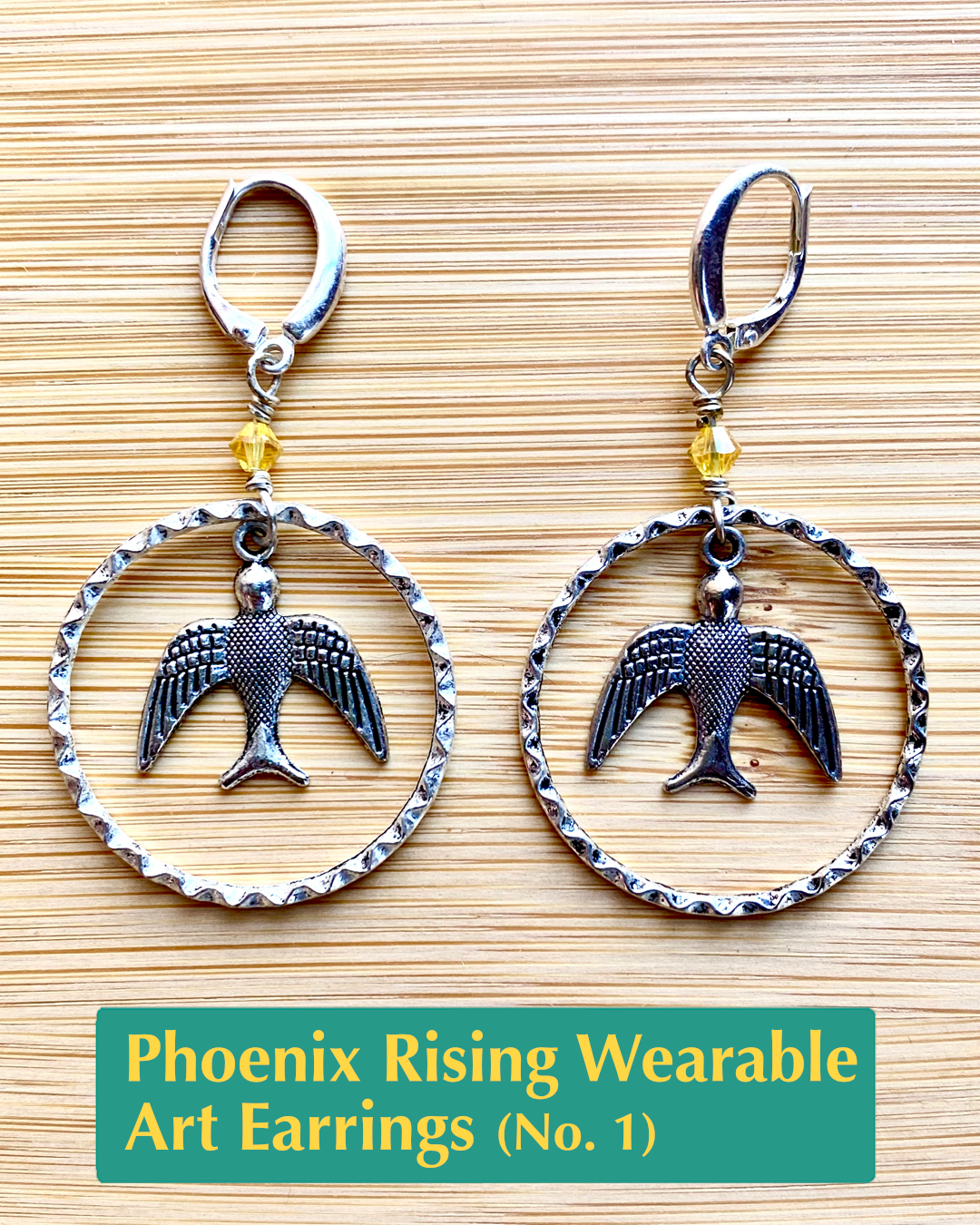 Handmade, wearable art lever back earrings with yellow crystal accents, a silver bird charm dangle, inside of textured hoops