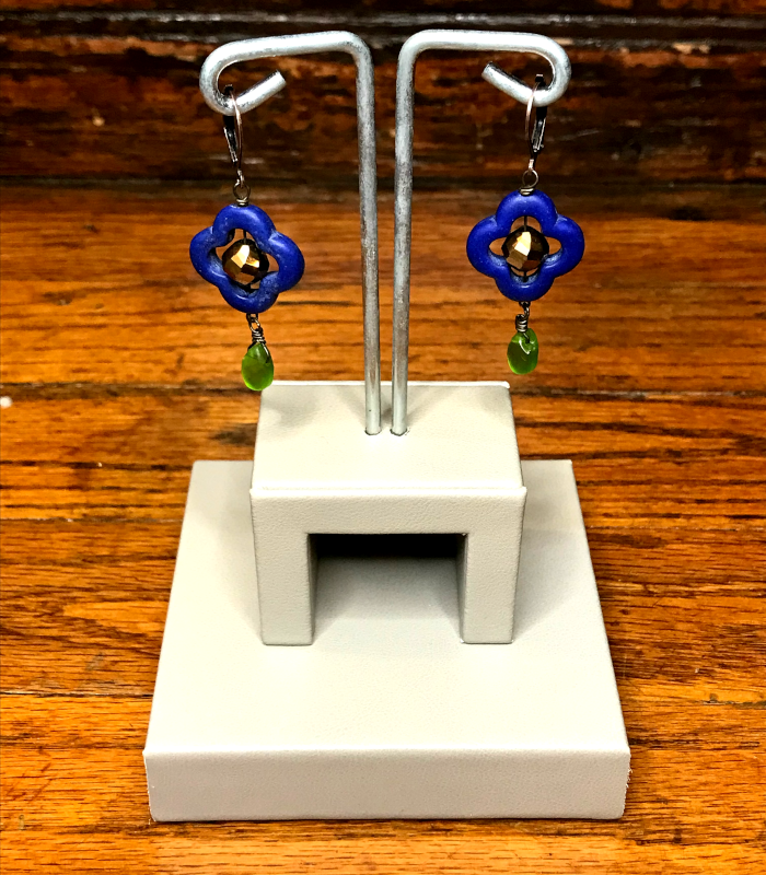Handmade, wearable art quatrefoil dangle earrings on display